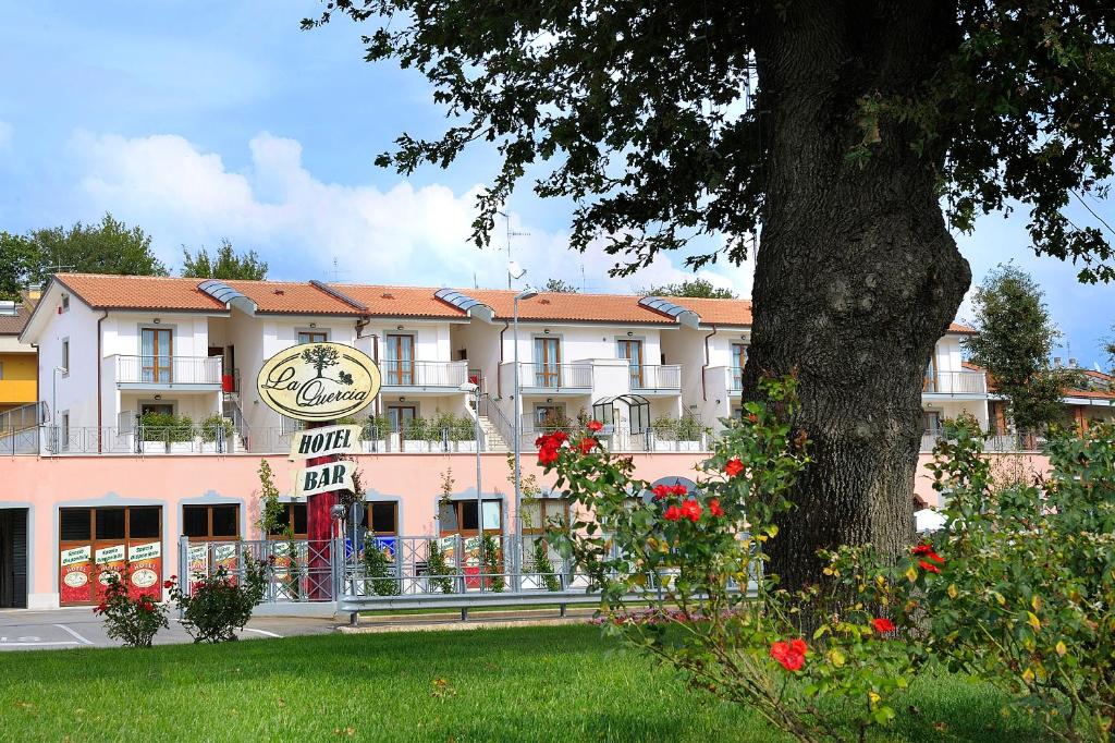 a building with a clock on the front of it at Hotel La Quercia in Valmontone