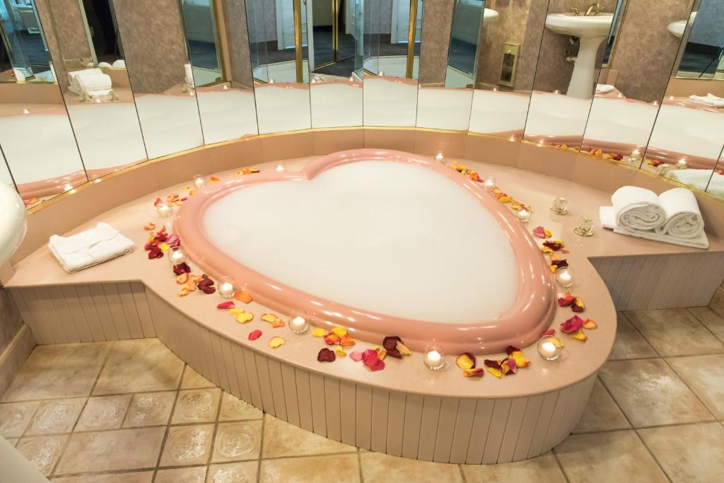 La salle de bains est pourvue d'une baignoire et de fleurs. dans l'établissement Cove Haven Resort, à Lakeville