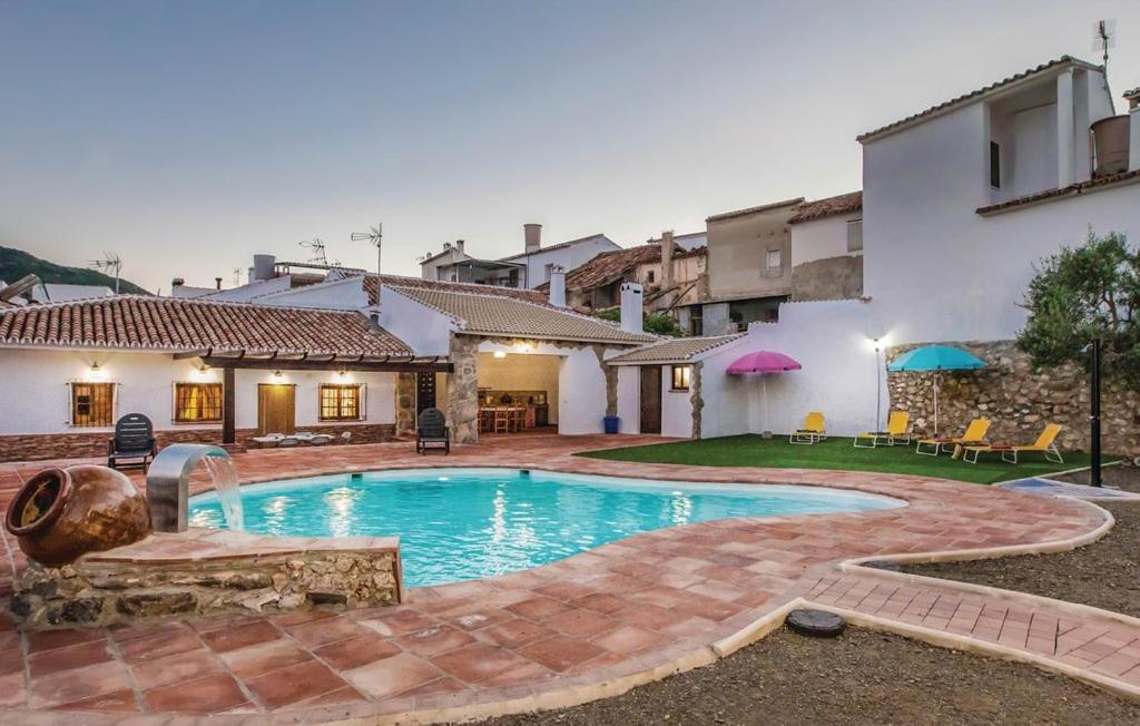 a swimming pool in the backyard of a house at Villa Godoy in Periana