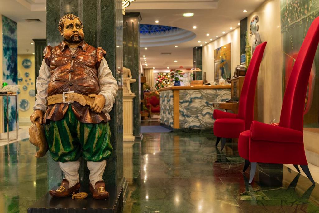 a statue of a man standing in a lobby at Hotel Sancho in Madrid