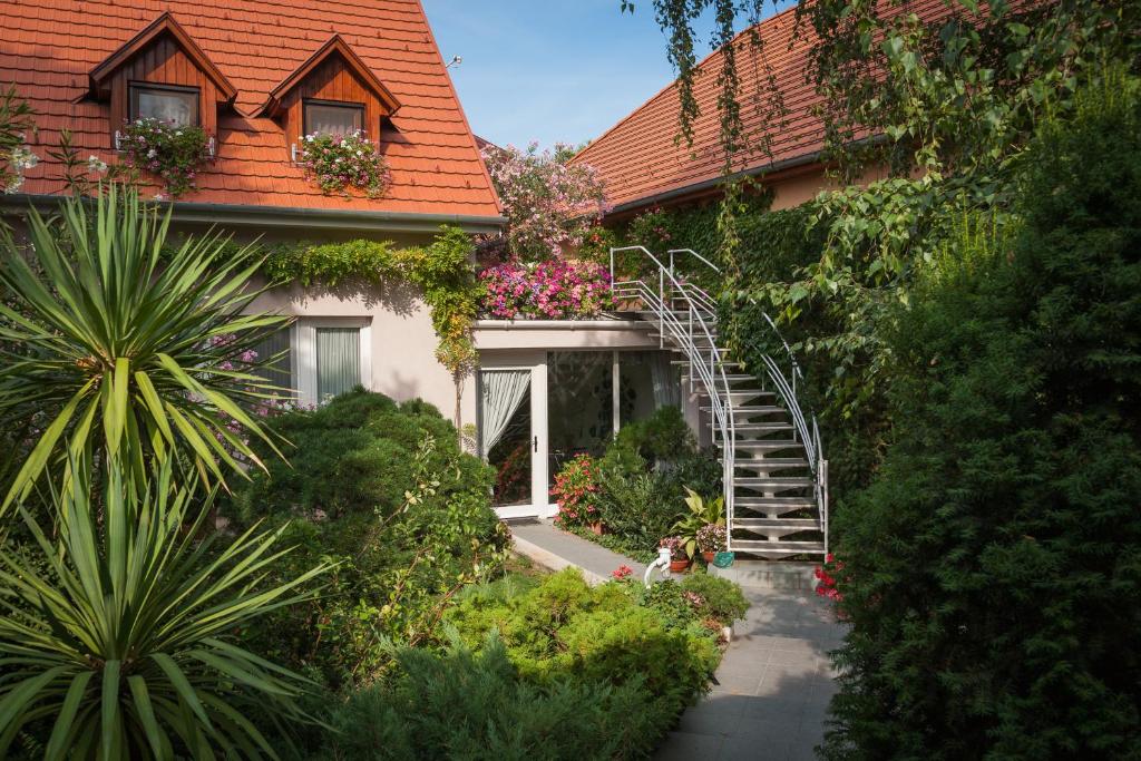 a house with a staircase in front of it at F&aacute;bi&aacute;n Panzi&oacute; in Kecskem&eacute;t