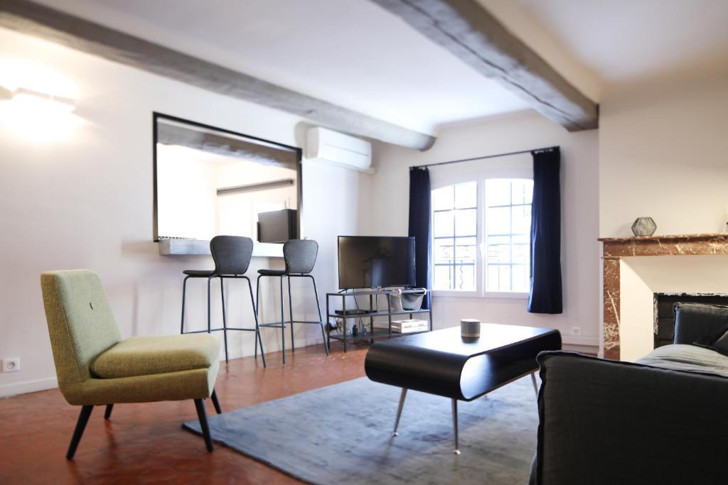 uma sala de estar com um sofá e cadeiras e uma lareira em Maison Alberta em Aix-en-Provence