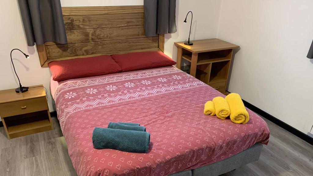 a bedroom with a bed with two yellow shoes on it at Studio CENTRAL 1 in Aosta