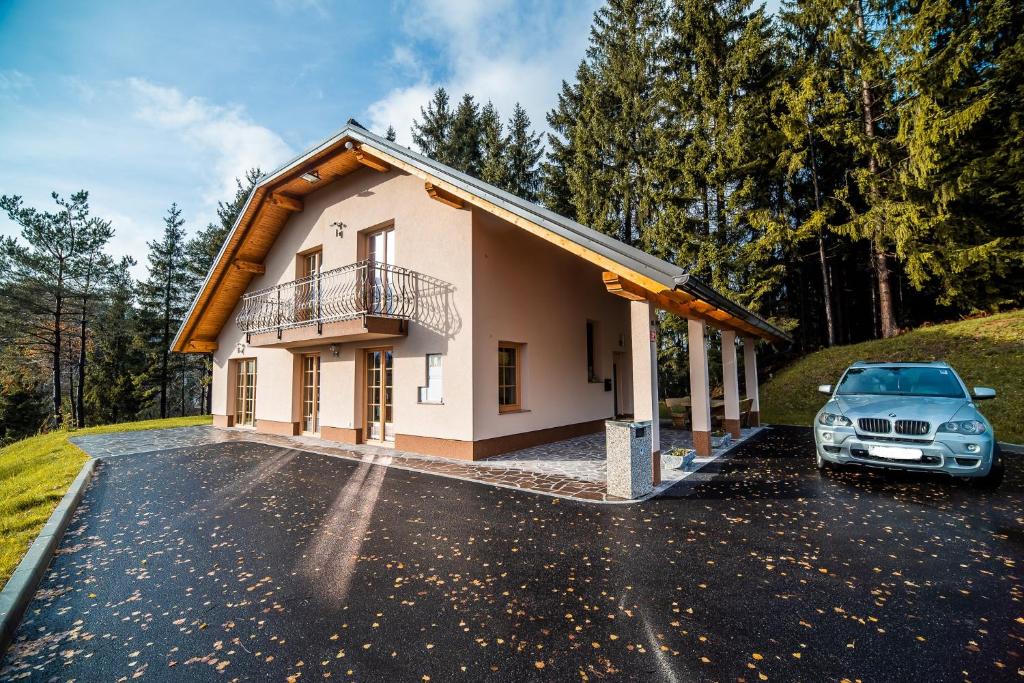 a car parked in a parking lot in front of a house at Holiday Home with Hot tub and Sauna Sabina in Rovte