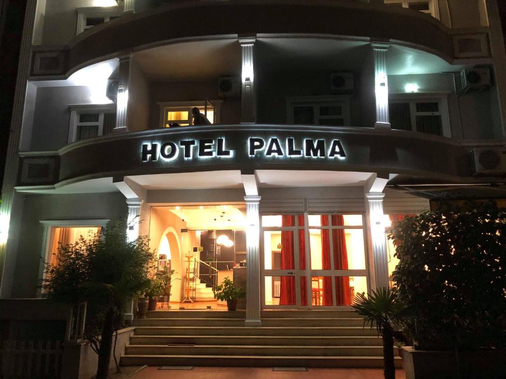 a hotel palma is lit up at night at Hotel Palma in Tirana