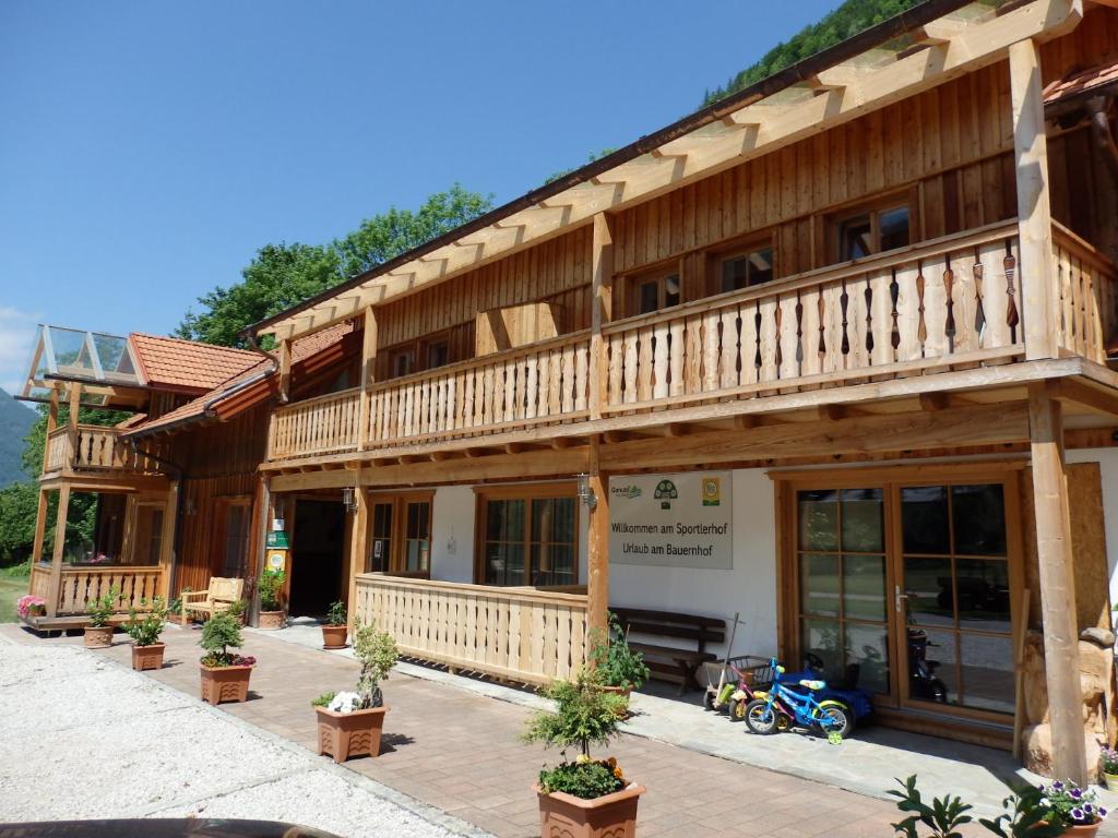 a building with a motorcycle parked in front of it at Sportlerhof in Grünau im Almtal