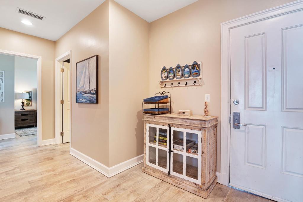 a hallway with a white door and a room at Reflections at Bay Point in Panama City Beach