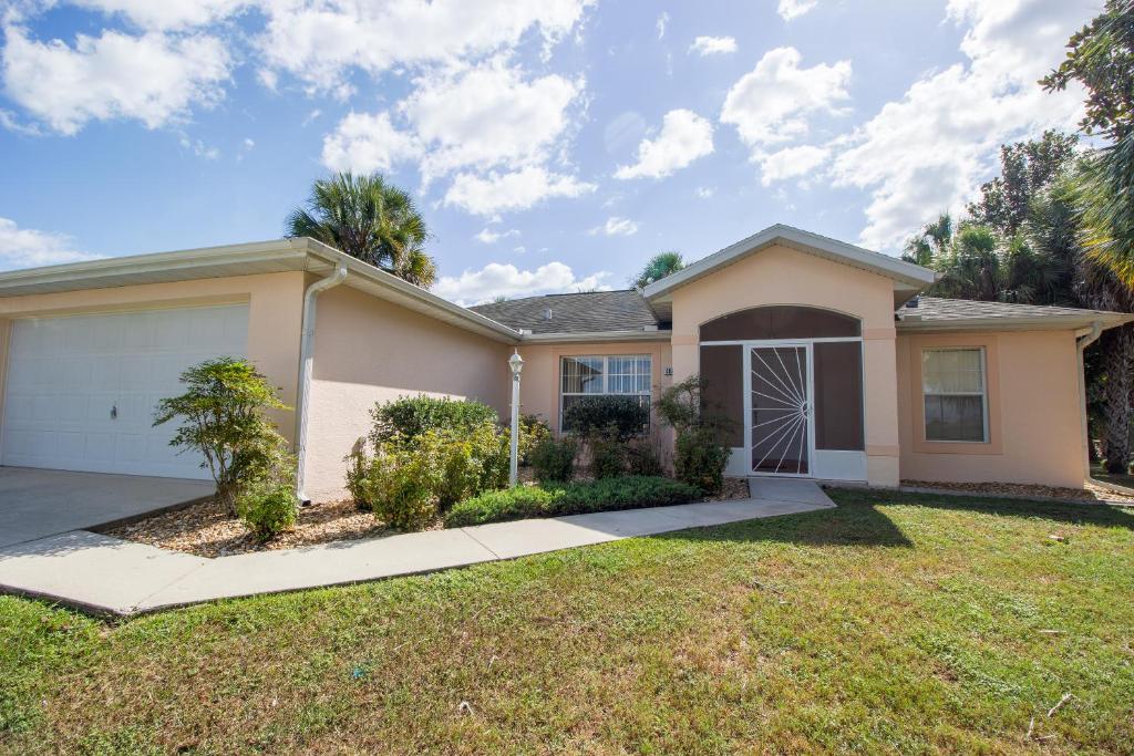 a house with a large yard in front of it at Van Ness Poolhome - Lake access 2mi in Hernando