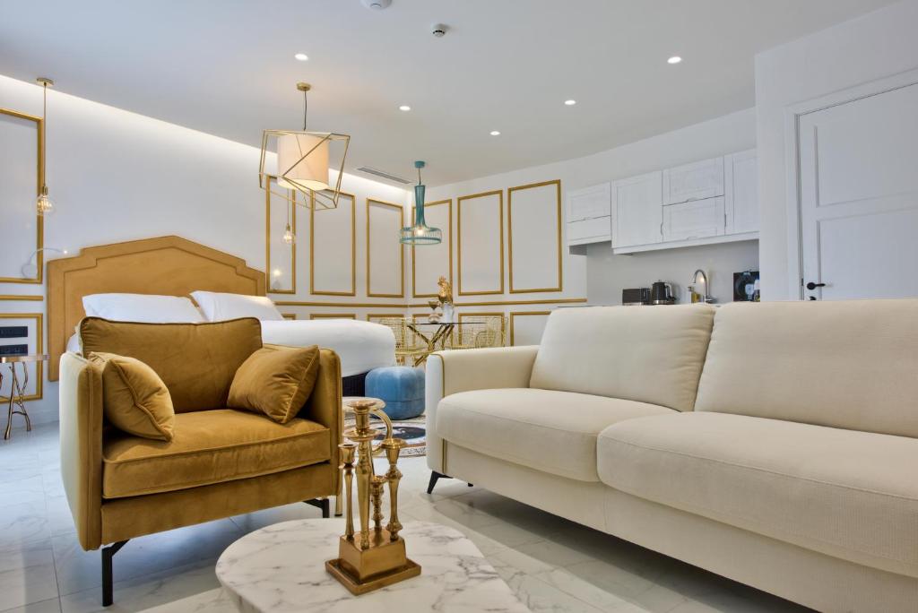 a living room with a couch and a chair at HOLM Boutique & SPA - IK Collection in St. Julianʼs