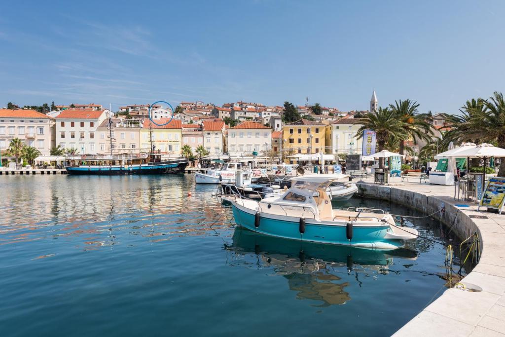a group of boats are docked in a harbor at Apartments Mirakul in Mali Lošinj
