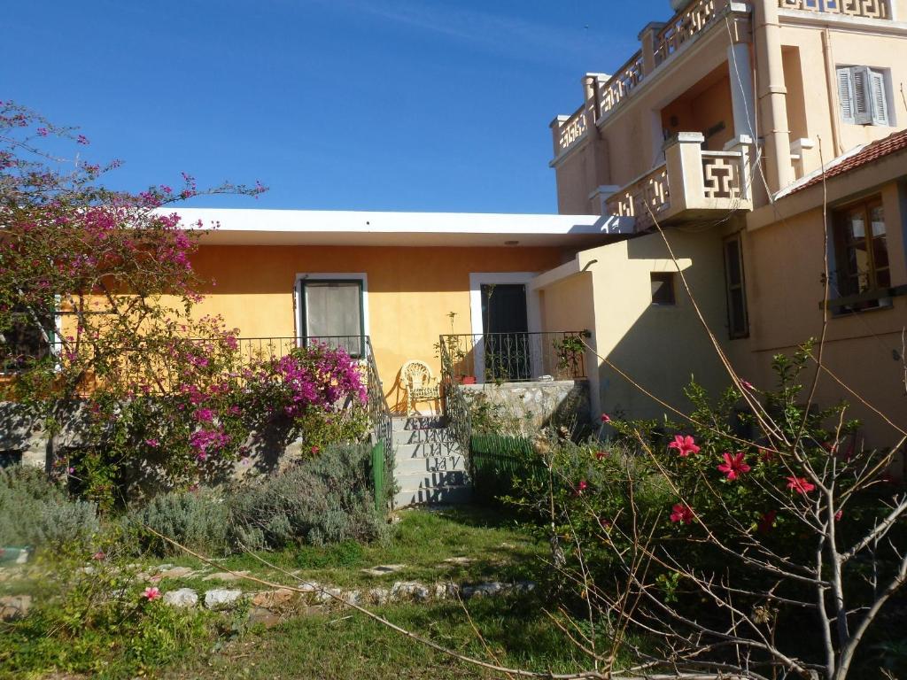 a house with flowers in front of it at Villa Afrodite in Symi