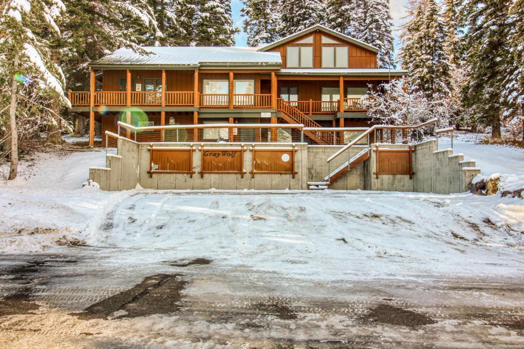 a large house in the snow with a driveway at Gray Wolf Condos at Whitefish in Whitefish