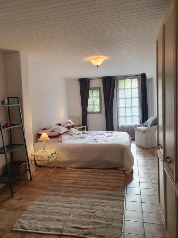 a bedroom with a large bed in a room at Les Hirondelles in Pont-de-Barret