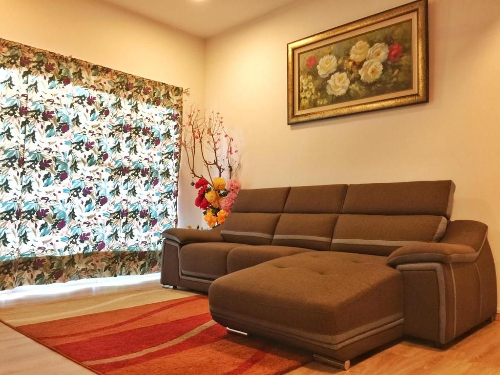a living room with a couch and a window at Cameron Highland Guesthouse in Tanah Rata
