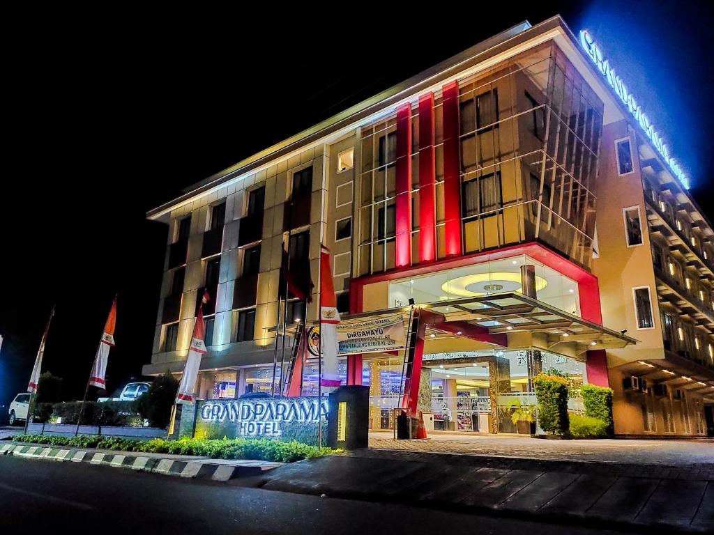 a building with red and yellow lights on it at Grand Parama Hotel in Tanjungredep