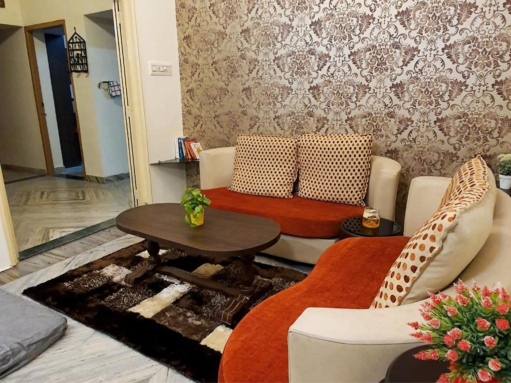 a living room with a couch and a table at Aditya Premium HomeStay- Furnished Air Conditioned- 2BHK in Jabalpur