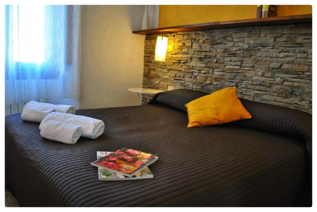 a bed with two towels and a tray of food on it at B&B Leopoldo in Florence