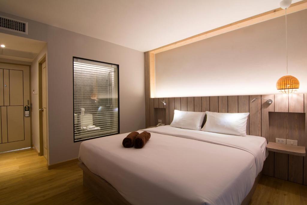 Ein Bett oder Betten in einem Zimmer der Unterkunft Baan Karon Resort