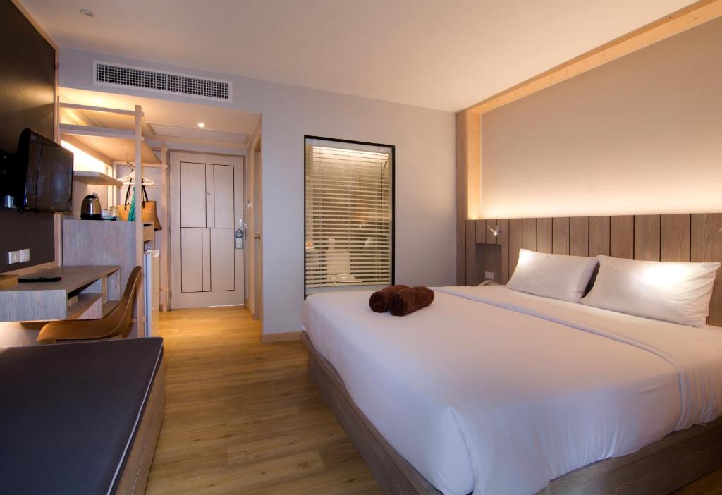 Ein Bett oder Betten in einem Zimmer der Unterkunft Baan Karon Resort