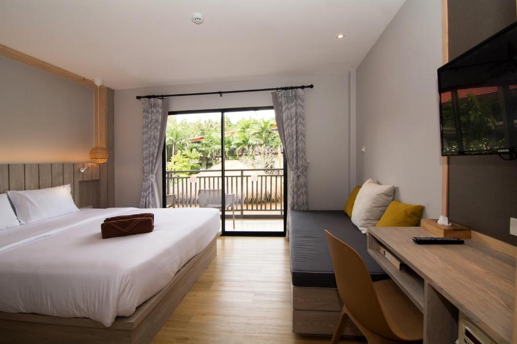 Ein Bett oder Betten in einem Zimmer der Unterkunft Baan Karon Resort