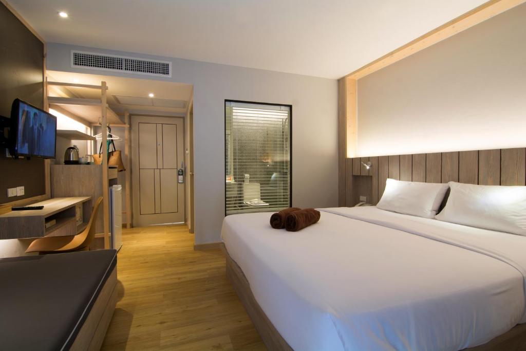 Ein Bett oder Betten in einem Zimmer der Unterkunft Baan Karon Resort