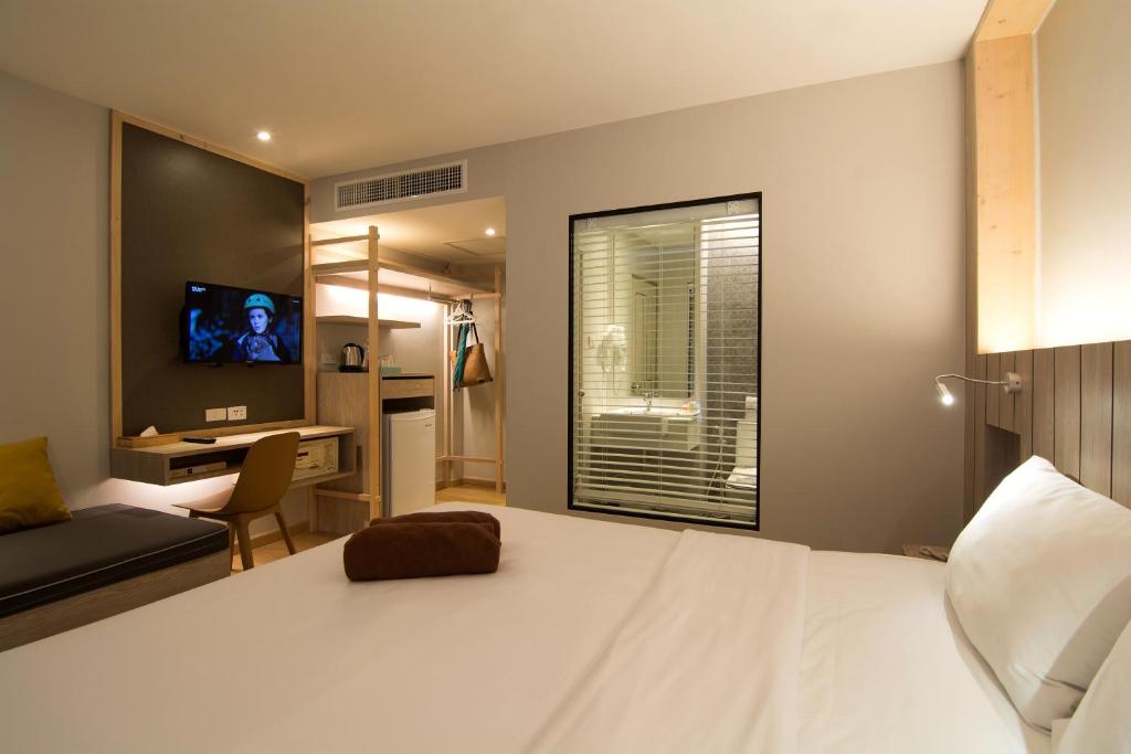 Ein Bett oder Betten in einem Zimmer der Unterkunft Baan Karon Resort
