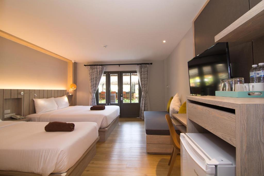 Ein Bett oder Betten in einem Zimmer der Unterkunft Baan Karon Resort