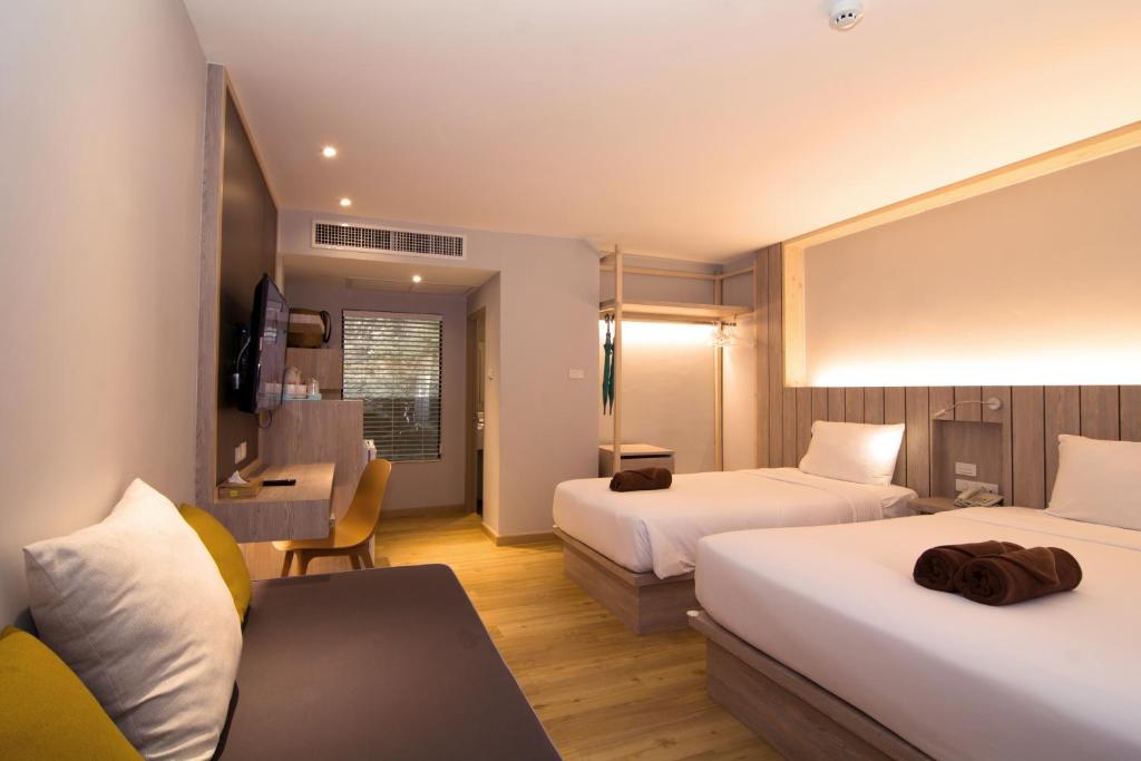 Ein Bett oder Betten in einem Zimmer der Unterkunft Baan Karon Resort