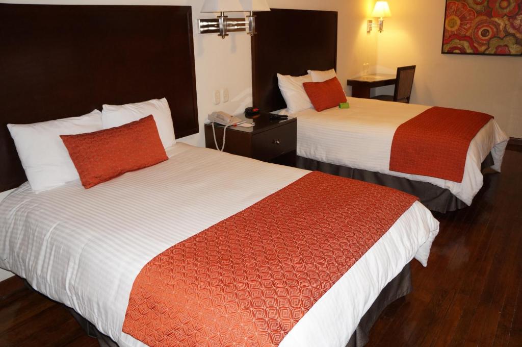 Postel nebo postele na pokoji v ubytování Hotel Plaza Chihuahua