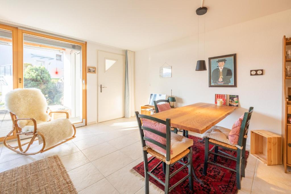 a dining room with a wooden table and chairs at Casa La Prada in Flims