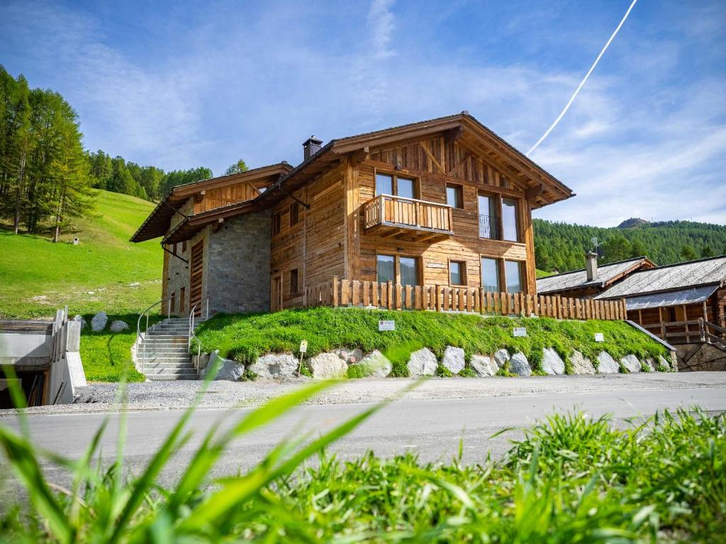 a large wooden house on top of a hill at Chalet La Dolce Vita MyHoliday in Livigno