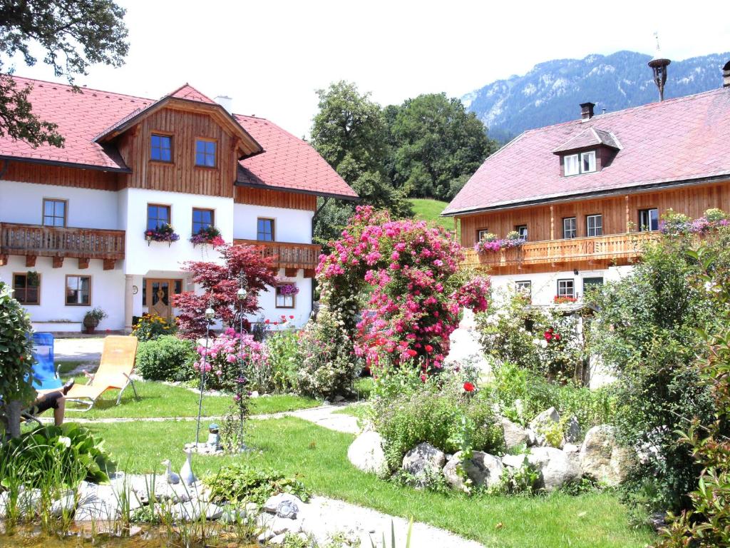 a garden in front of a house with flowers at Biohaus Florian in Haus im Ennstal