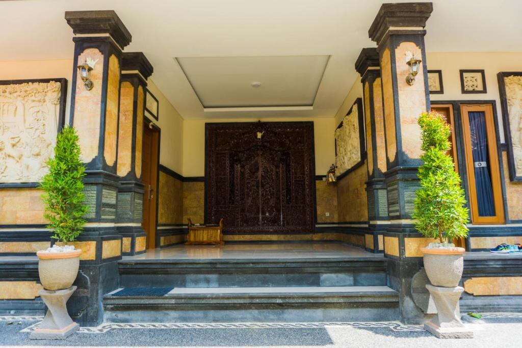 a large entrance to a building with a large door at Cakra House in Denpasar