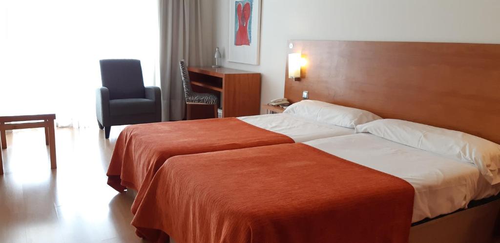 Postel nebo postele na pokoji v ubytování Hotel Torre Monreal