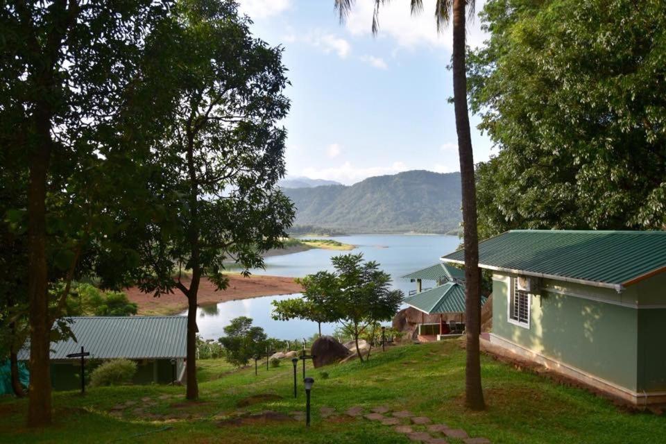 a house with a view of a body of water at Diga vista resorts in Palakkad