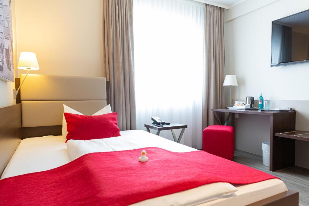 Postel nebo postele na pokoji v ubytování hotel bomonti Nürnberg West