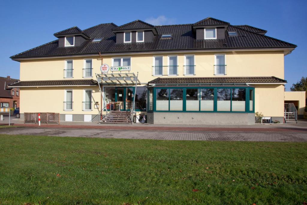 a large building with a store in front of it at City-Hotel in Friesoythe