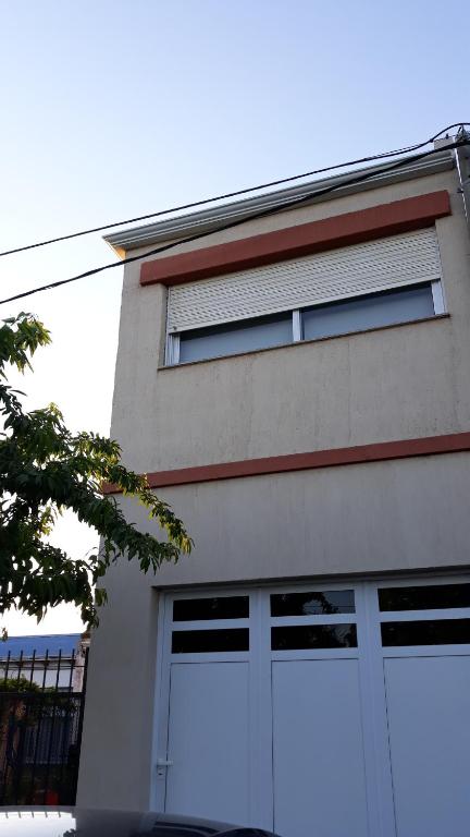 a building with two garage doors on the side of it at El Sueño de Teresita in Bahía Blanca