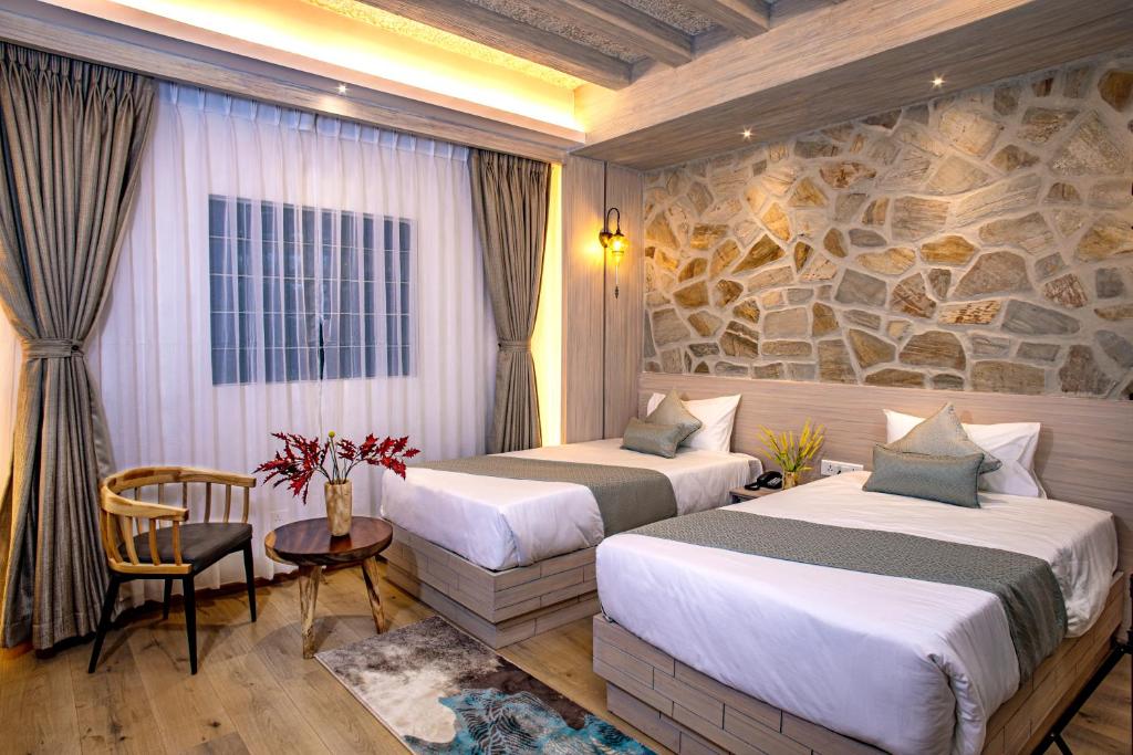 Postel nebo postele na pokoji v ubytování Arushi Boutique Hotel