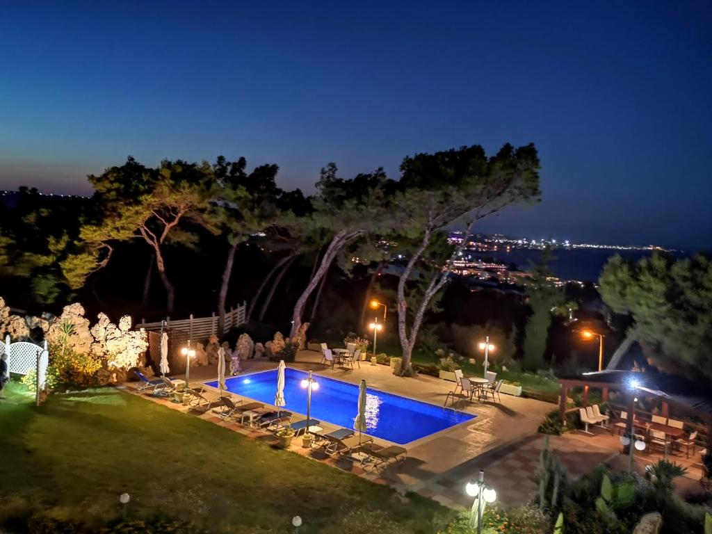 a view of a swimming pool at night at Louis Luxury Villa by filoxenia in blue in Rhodes Town