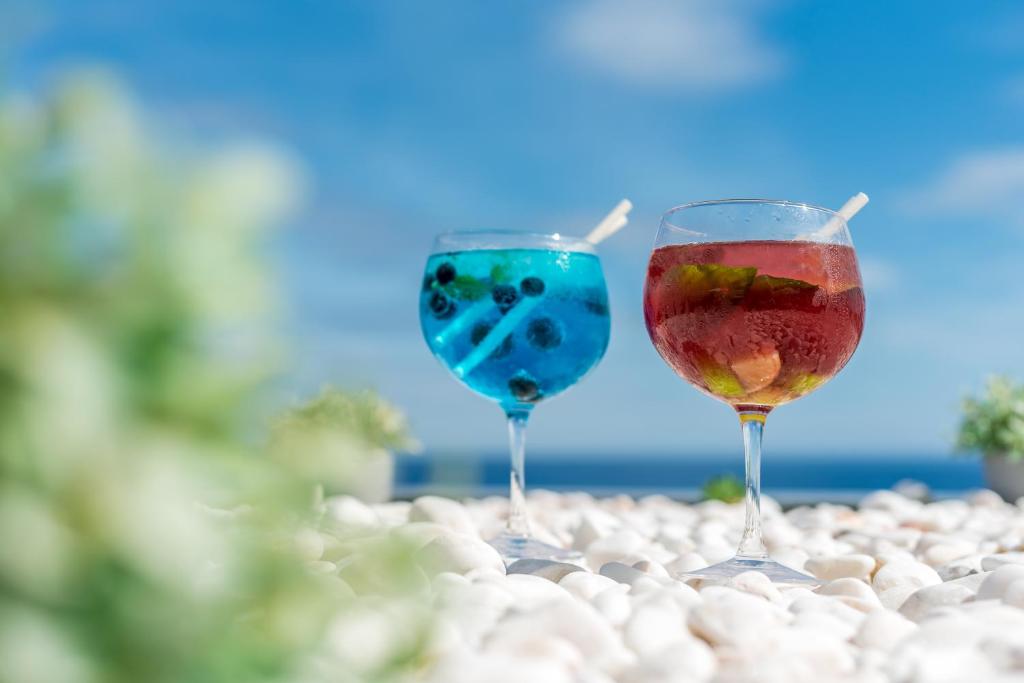 two glasses of wine sitting on a table at Aqua Natura Madeira in Porto Moniz