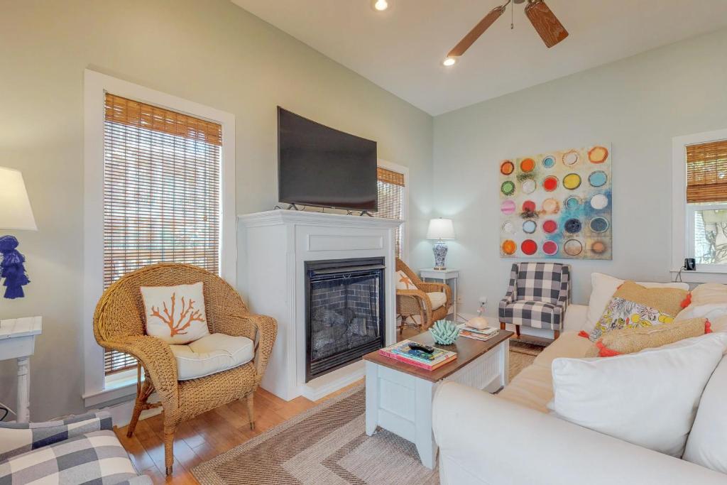 a living room with a couch and a fireplace at The Lemon Drop in Rosemary Beach