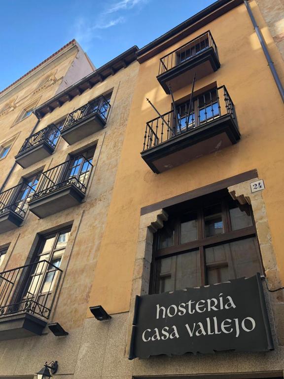 a building with a sign on the side of it at Hosteria Casa Vallejo in Salamanca