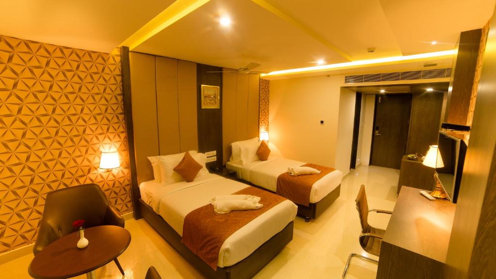 Postel nebo postele na pokoji v ubytování Hotel Indraprasttha