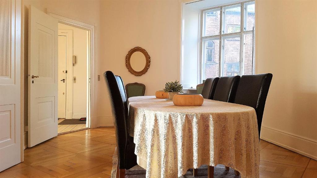 a dining room with a table with a pumpkin on it at Aaboulevard Apartment in Copenhagen