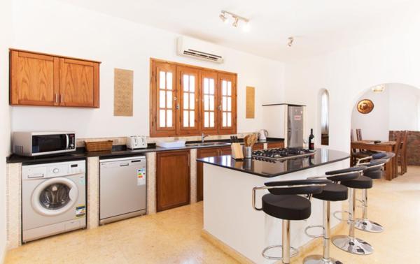 a kitchen with a stove and a dishwasher at Red Rock Apartments in Dahab