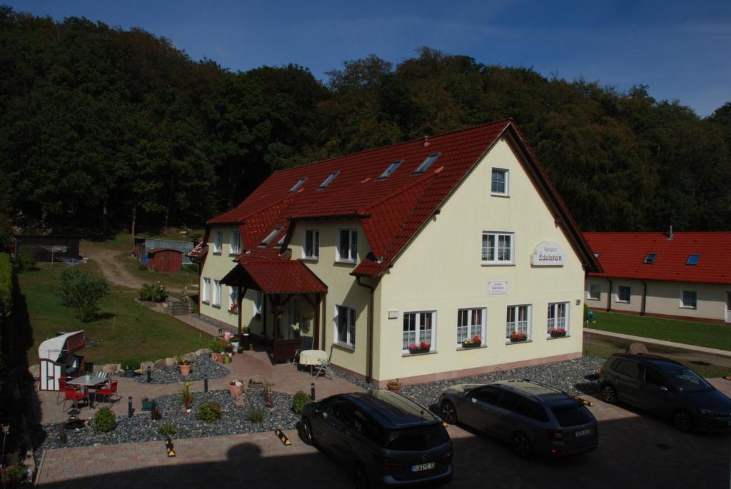 a large white house with a red roof at Pension Edelstein in Ostseebad Sellin