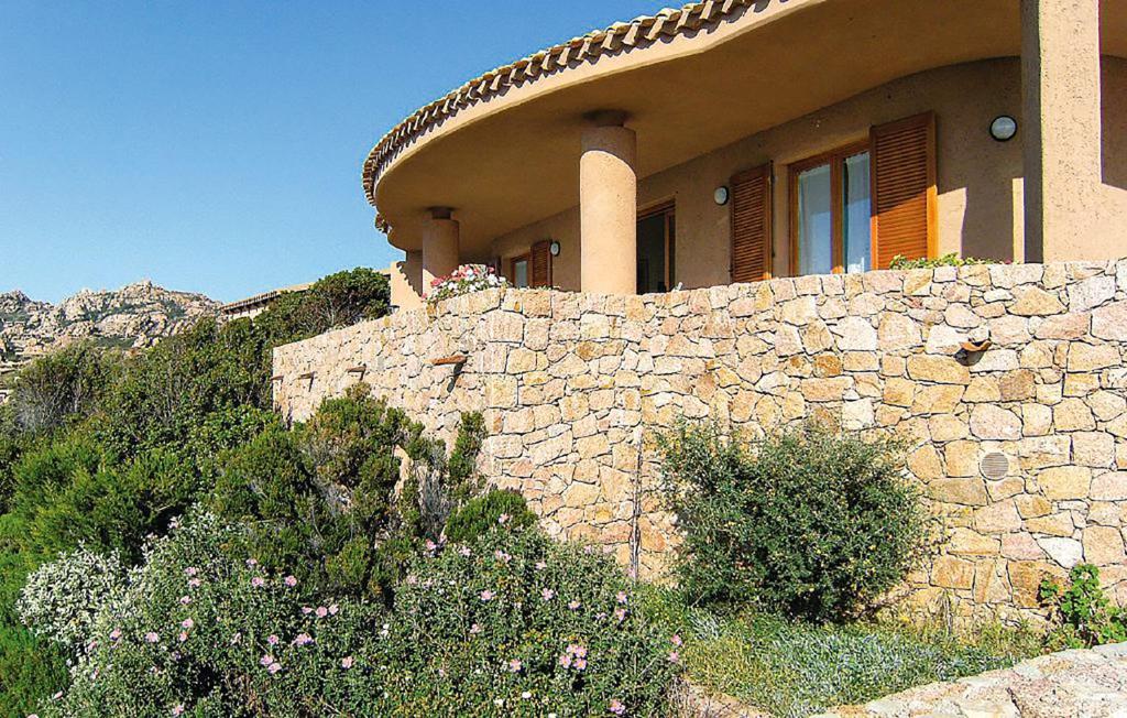 a stone wall in front of a house at Villa Cecilia in Costa Paradiso