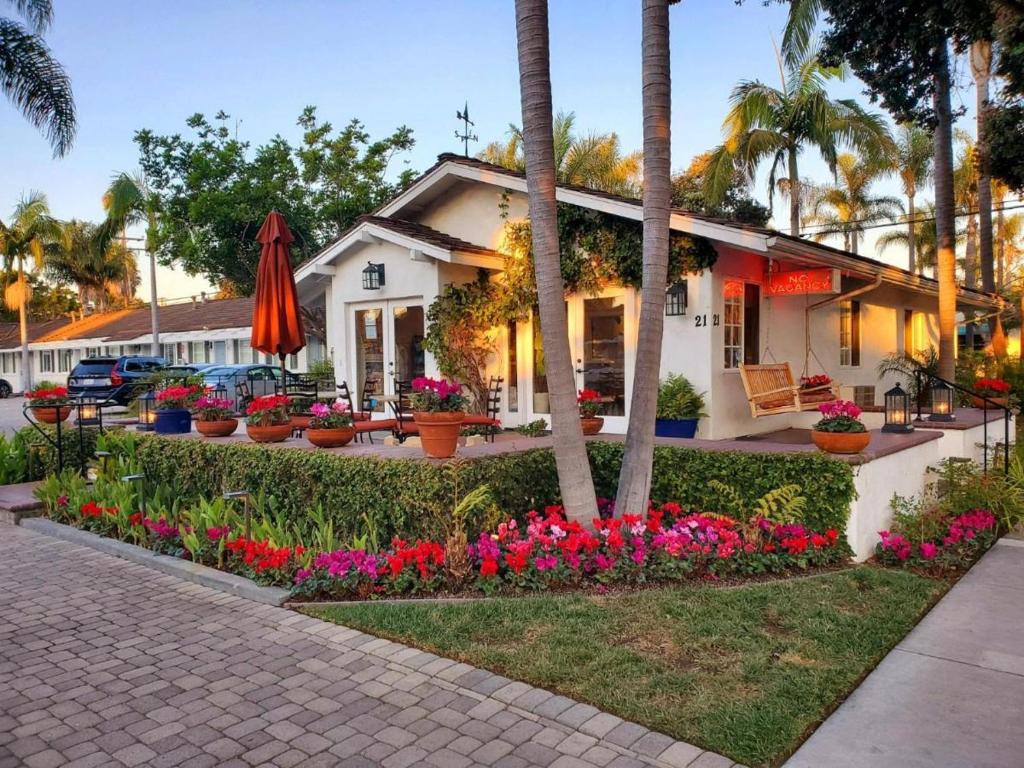 a house with a lot of flowers in front of it at Marina Beach Motel in Santa Barbara