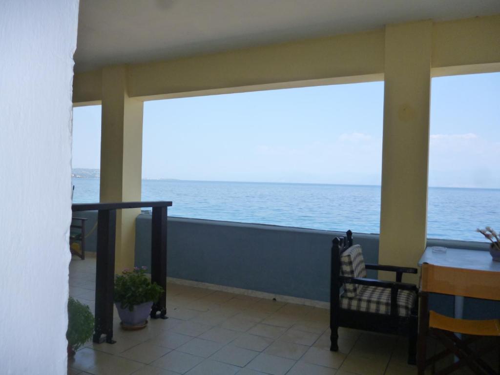 a balcony with a view of the ocean at House next to the sea side in Derveni